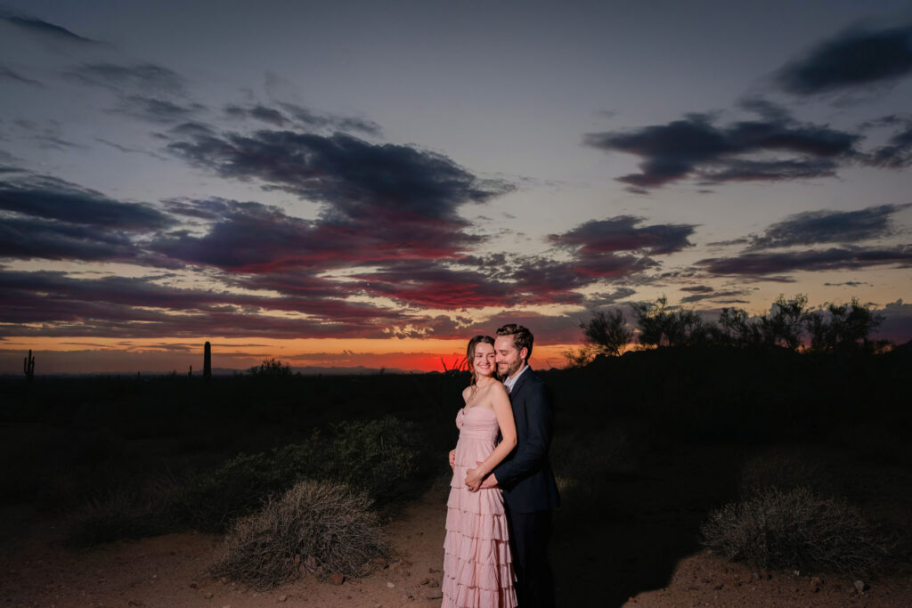 Bride-to-be and groom-to-be sharing a quiet moment during their Lost Dutchman engagement session, highlighting natural connection and warm desert light.
