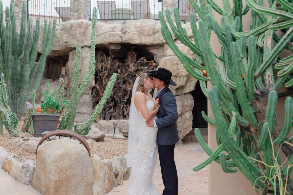 Newlyweds embracing in warm sunset light with the mountains behind them during their Tucson wedding.