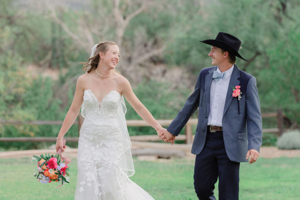Bride and groom walking through the desert at golden hour, photographed by an Arizona wedding photographer.
