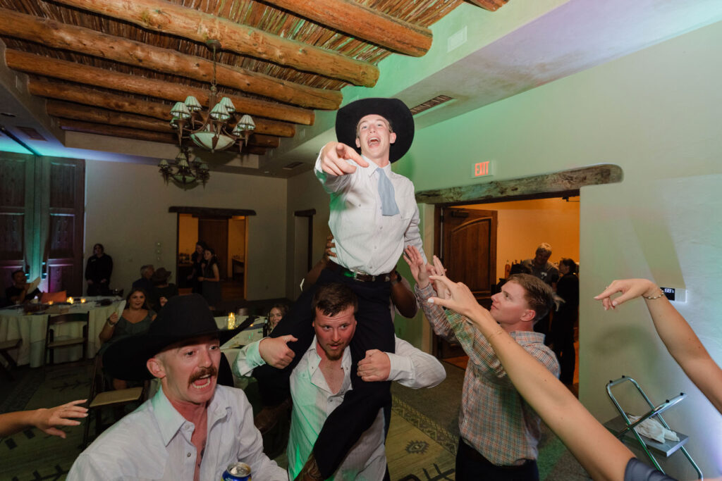 Guests dancing under the night sky at a Tucson ranch wedding reception.