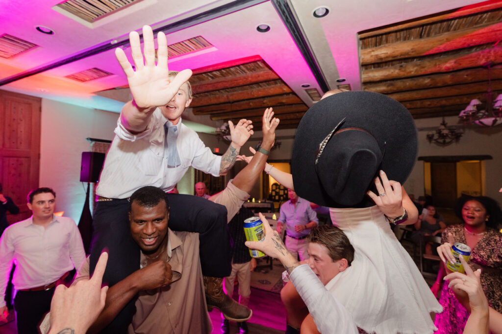 Guests enjoying dinner under string lights during an outdoor wedding reception in Arizona.