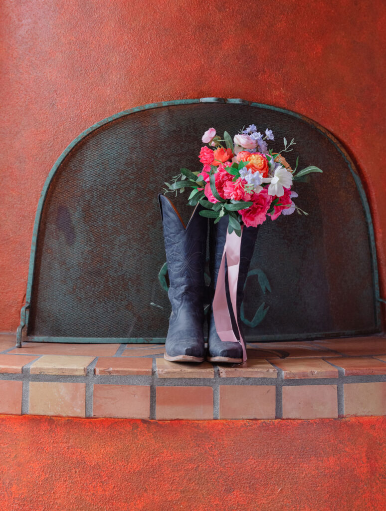 Close up of wedding rings and invitation suite styled on textured linens at Tanque Verde Ranch in Arizona.