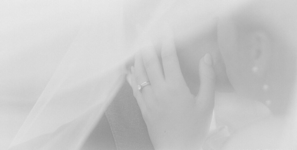 Golden hour wedding portrait of bride and groom laughing together in the Arizona desert.