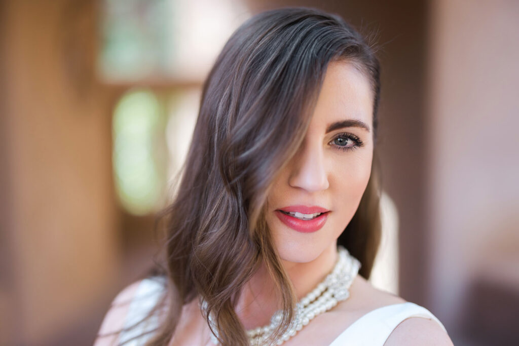 Golden hour elopement photo of bride and groom with the Sedona cliffs glowing in the background.