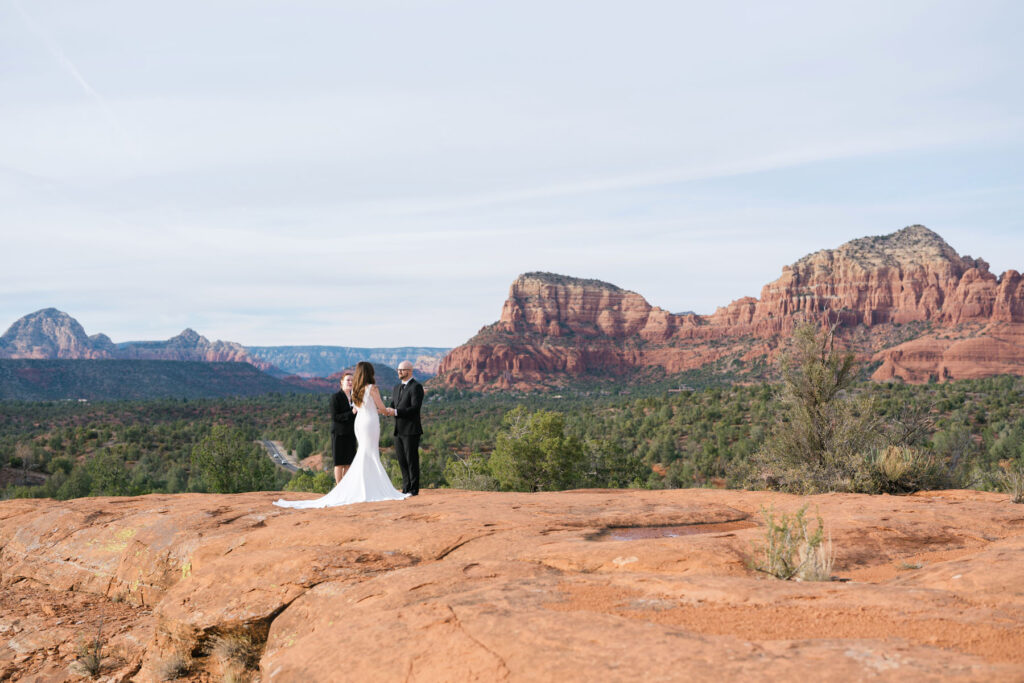 1. Couple exchanging vows during a small Bell Rock elopement ceremony in Sedona, Arizona.
