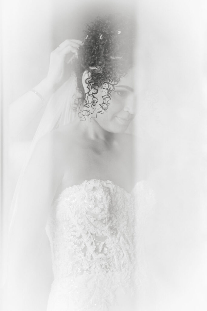 Bride getting ready in a casita style suite at Hacienda Del Sol with soft natural window light.