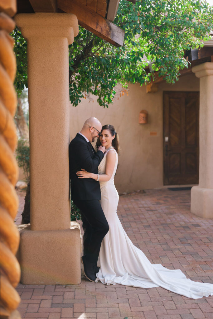 Romantic portrait of a couple in wedding attire standing against the red rock landscape at Bell Rock.