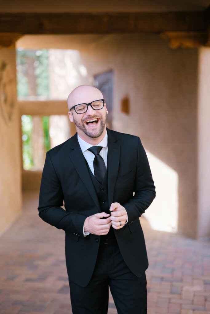 Candid moment of the couple laughing together on the Bell Rock trail during their Sedona elopement.