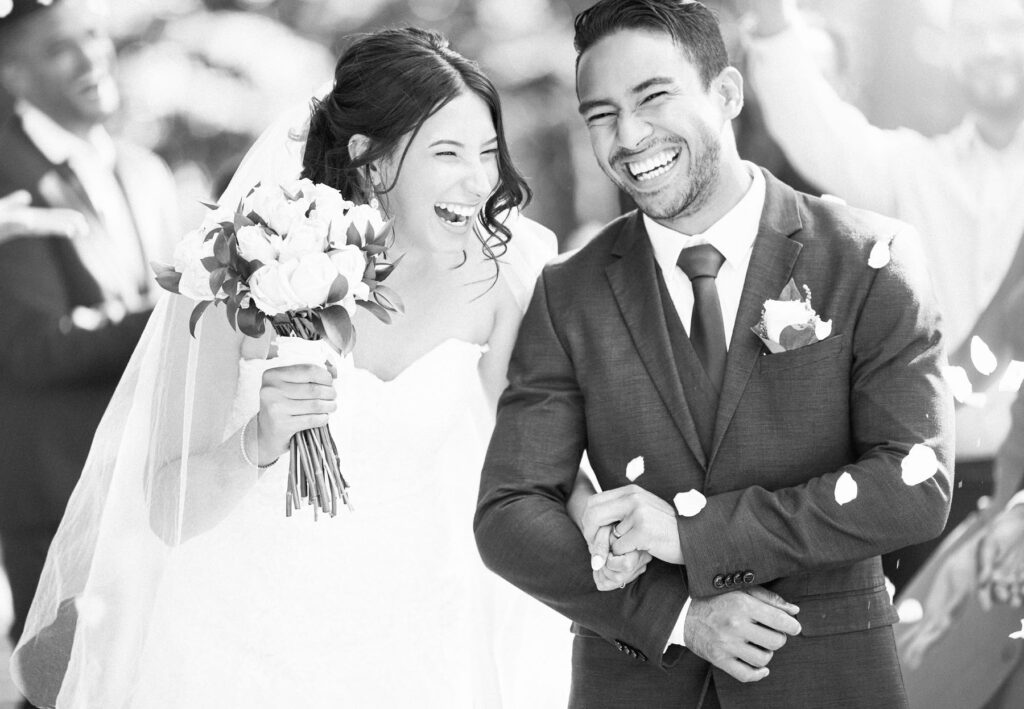 Couple standing in a landscaped courtyard at a luxury Phoenix hotel wedding venue.