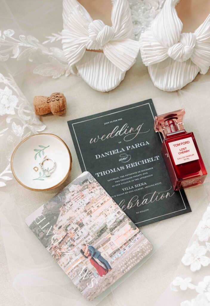 Wedding details included pleated satin shoes, Tom Ford Lost Cherry perfume, and an elegant wedding invitation for a wedding at Villa Siena in Gilbert Arizona.