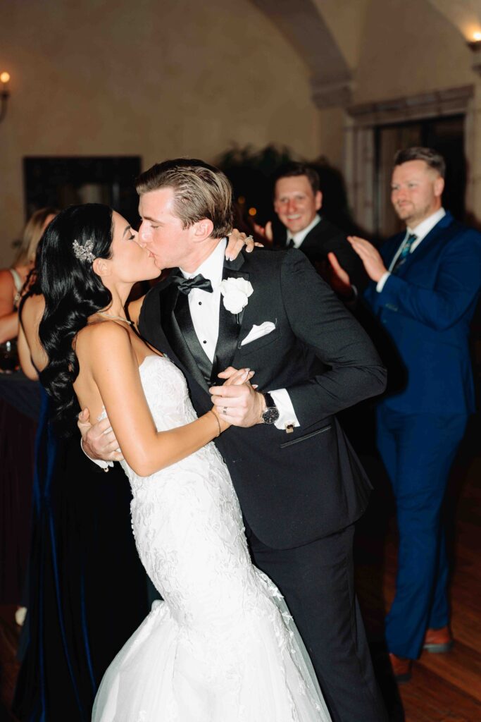 A bride and groom kiss in their classy wedding reception space in Gilbert Arizona after being announced for the first time as husband and wife.  
