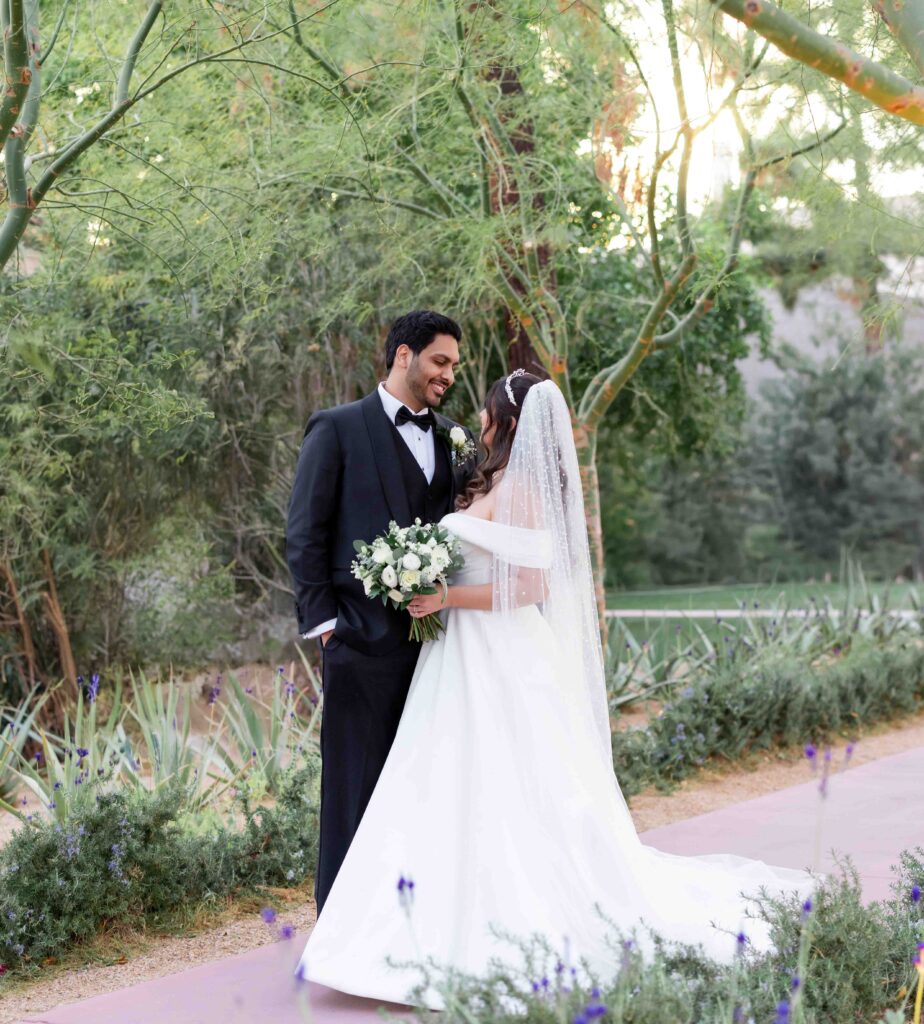 A newly married couple takes portraits in the gardens at Biltmore wedding venue in Scottsdale Arizona. 